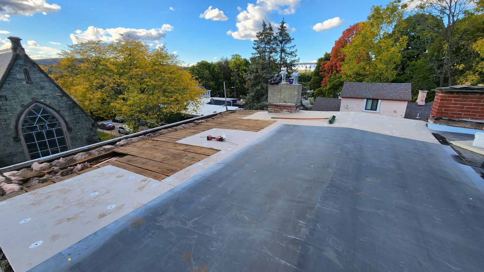 EPDM membrane going down on a historic Poughkeepsie building with the railroad bridge in view