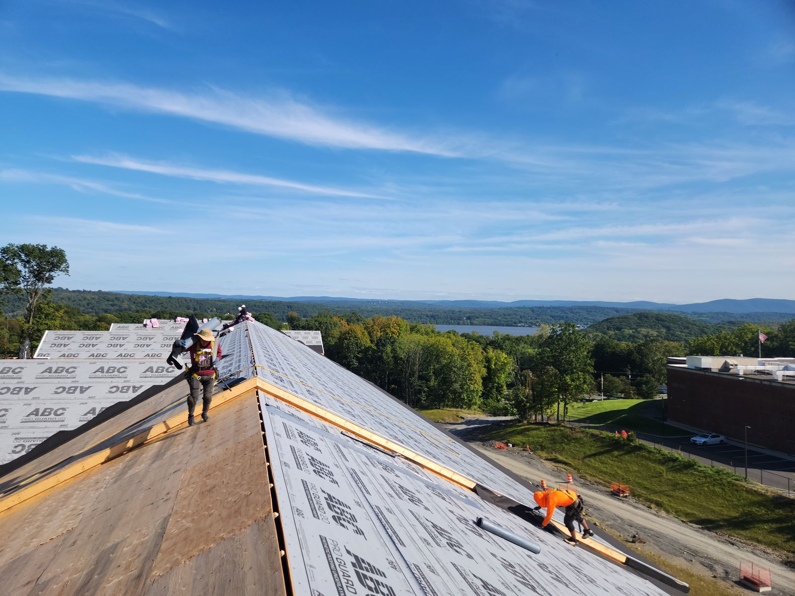 Roofers drying in a new construction roof overlooking the Hudson River